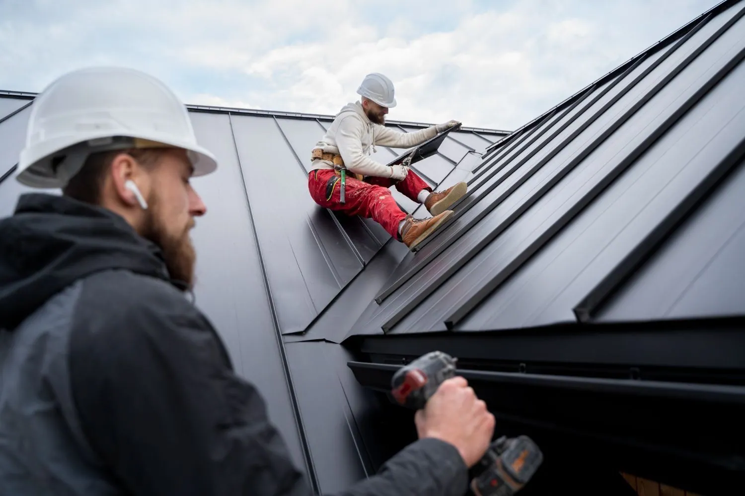 A group of men are working on the roof of a building.
