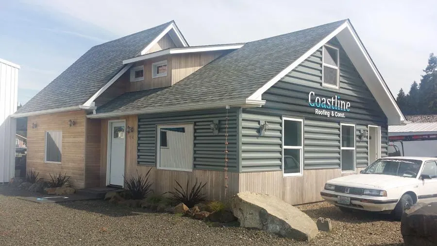 A white car is parked in front of a building that says crashine